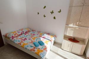 a bedroom with a bed with butterflies on the wall at Apartments with a parking space Pavicini, Marcana - 21315 in Pavicini