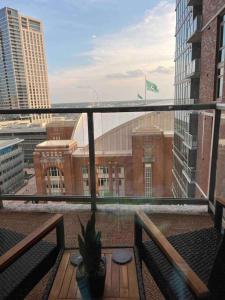 a balcony with a table and a view of a building at Opulence is a way of life in Dallas