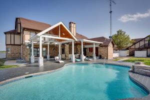 a swimming pool in front of a house at Texas Ranch Vacation Rental with Outdoor Pool! in Commerce