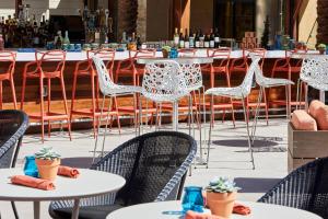 a row of tables and chairs with white chairs at Los Angeles Marriott Burbank Airport in Burbank