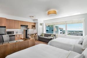 a hotel room with two beds and a kitchen at Element Calgary Airport in Calgary