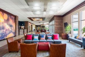 a lobby with a couch and chairs in a building at Four Points by Sheraton Chicago O'Hare in Schiller Park