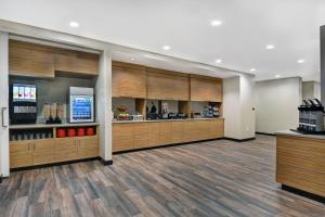 a large lobby with wood paneling and a waiting room at TownePlace Suites by Marriott Sarasota/Bradenton West in Bradenton