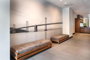 a hallway with benches and a mural of a bridge at Four Points by Sheraton - San Francisco Bay Bridge in Emeryville