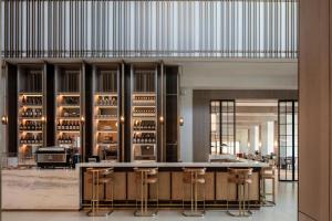 a lobby with a bar and stools at Sheraton Grand Tel Aviv in Tel Aviv