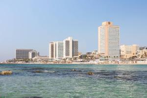 a view of a city from the water with buildings at Sheraton Grand Tel Aviv in Tel Aviv