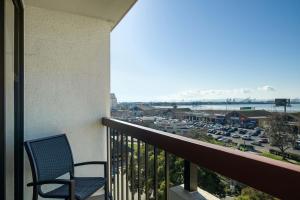 a balcony with a chair and a view of a parking lot at Four Points by Sheraton - San Francisco Bay Bridge in Emeryville