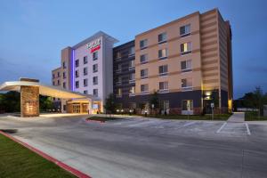 a hotel with a parking lot in front of it at Fairfield Inn & Suites by Marriott Austin San Marcos in San Marcos