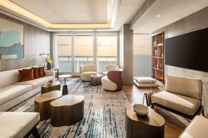 a living room with a couch and a tv at Sheraton Grand Tel Aviv in Tel Aviv
