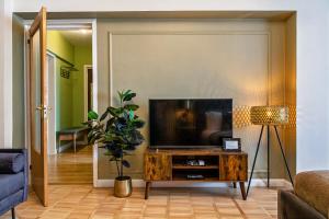 a living room with a television on a table at Designer Flat for 4, Heart of Bucharest, Kitchen in Bucharest