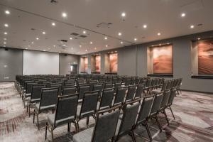 an empty lecture room with chairs and a screen at Courtyard by Marriott Ciudad Juarez in Ciudad Juárez