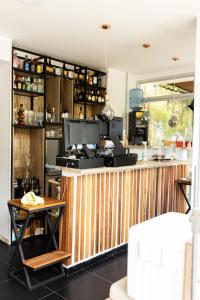 a kitchen with a wooden counter and a table at Hotel Brisas del Nus in San Roque