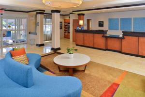a lobby with a blue couch and a table at Fairfield Inn & Suites Kingsland in Kingsland
