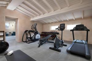 a gym with several treadmills and elliptical machines at Grand Universe Lucca, Autograph Collection in Lucca