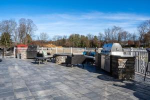 a patio with a grill and tables and chairs at TownePlace Suites by Marriott Clinton in Clinton