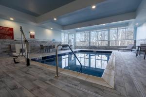 a large swimming pool in a building with a pool at TownePlace Suites by Marriott Clinton in Clinton