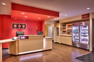 a lobby of a store with red walls and a cash register at TownePlace Suites by Marriott Dickinson in Dickinson