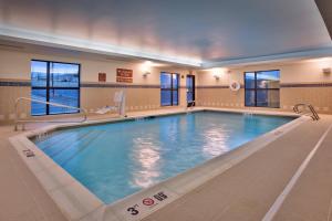 a large pool in a hotel room with a large swimming pool at TownePlace Suites by Marriott Dickinson in Dickinson