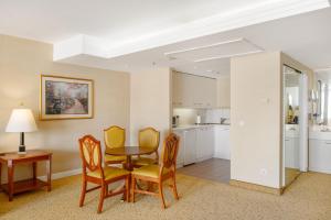 a kitchen and dining room with a table and chairs at Millennium Court, Budapest - Marriott Executive Apartments in Budapest