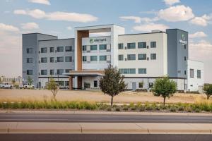 a large white building on the side of a road at Element Denver International Airport in Denver