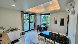 a kitchen and dining room with a table and a dining room at 莫民宿 MO Homestay in Yuanshan