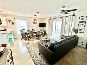 a living room with a black couch and a table at Emerald Hideaway condo in Navarre