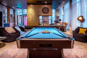 a billiard room with a pool table in it at Moxy Glasgow Merchant City in Glasgow