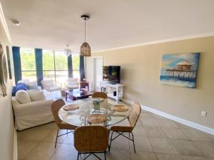 a living room with a table and chairs at Fun 2 bed/2 bath condo with pool on Biloxi Beach in Biloxi