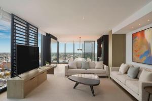 a living room with couches and a large television at The Westin Perth in Perth