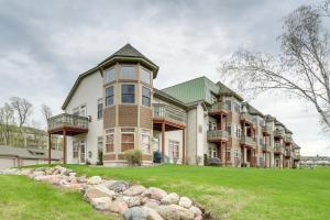 a large house with a lawn in front of it at Cozy Birchwood Condo on Tagalong Golf Course! in Birchwood
