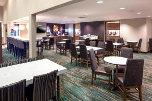a restaurant with tables and chairs and a bar at Residence Inn by Marriott Near Universal Orlando in Orlando