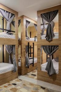 a room with four bunk beds in it at Ventiuna Hotel y Coliving in Pereira