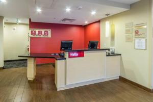 a lobby of a hooters restaurant with red walls at TownePlace Suites Dayton North in Dayton