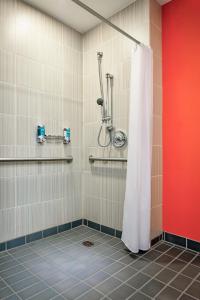 a bathroom with a shower with a white shower curtain at Aloft San Antonio Airport in San Antonio