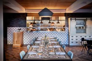 a dining room with a long table in a kitchen at The Casso, Raleigh, a Tribute Portfolio Hotel in Raleigh