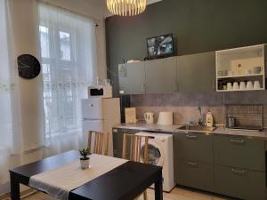 a kitchen with a table and a table and a kitchen with a stove at Casa Nora in Budapest