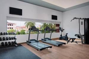 a gym with several tread machines and a large window at Four Points by Sheraton Batam in Nagoya