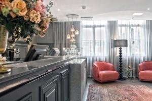 a living room with a counter with a vase of flowers at Clarion Collection Hotel Katajanokka in Helsinki
