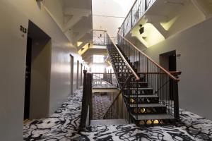 a winding staircase in a building with a carpet at Home Hotel Katajanokka in Helsinki