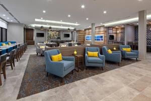 a lobby of a hotel with chairs and a bar at SpringHill Suites by Marriott Escondido Downtown in Escondido