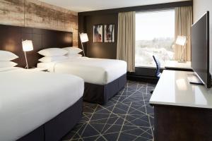 a hotel room with two beds and a window at Delta Hotels by Marriott Sherbrooke Conference Centre in Sherbrooke