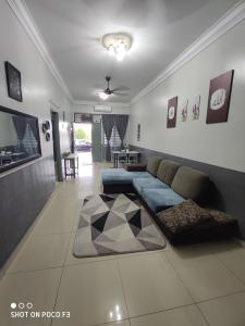 a living room with a couch and a tv at Umai homestay in Bandar  Pusat Jengka
