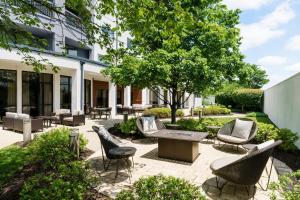 a patio with chairs and a table and a tree at Courtyard by Marriott Philadelphia Montgomeryville in North Wales