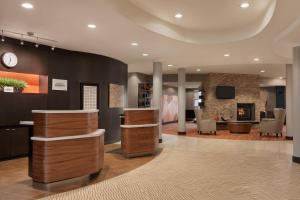 a lobby with a reception desk and a fireplace at Courtyard by Marriott Philadelphia Montgomeryville in North Wales