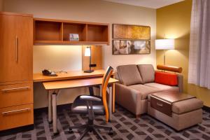 a hotel room with a desk and a chair and a couch at TownePlace Suites by Marriott Sierra Vista in Sierra Vista