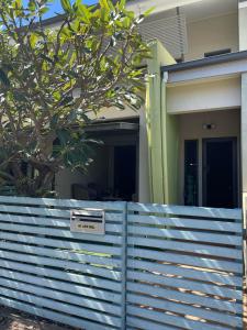 a fence with a sign in front of a house at Walk to Palmer B&B - U21 in Townsville