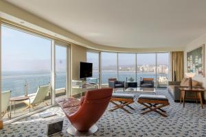 a living room with a view of the ocean at Sheraton Miramar Hotel & Convention Center in Viña del Mar