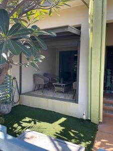 a patio with a table and chairs on a house at Walk to Palmer B&B - U21 in Townsville