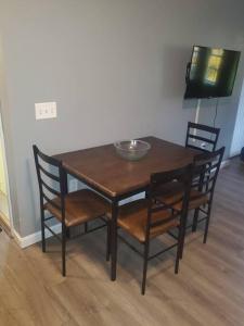 a wooden table with chairs and a bowl on top at Adorable 1 bedroom with off-street parking 