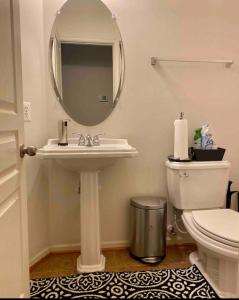 a bathroom with a sink and a mirror and a toilet at Van Gogh Guest Rm#6 • Van Gogh 6- Private BSMT Rm in single family home in Rosedale